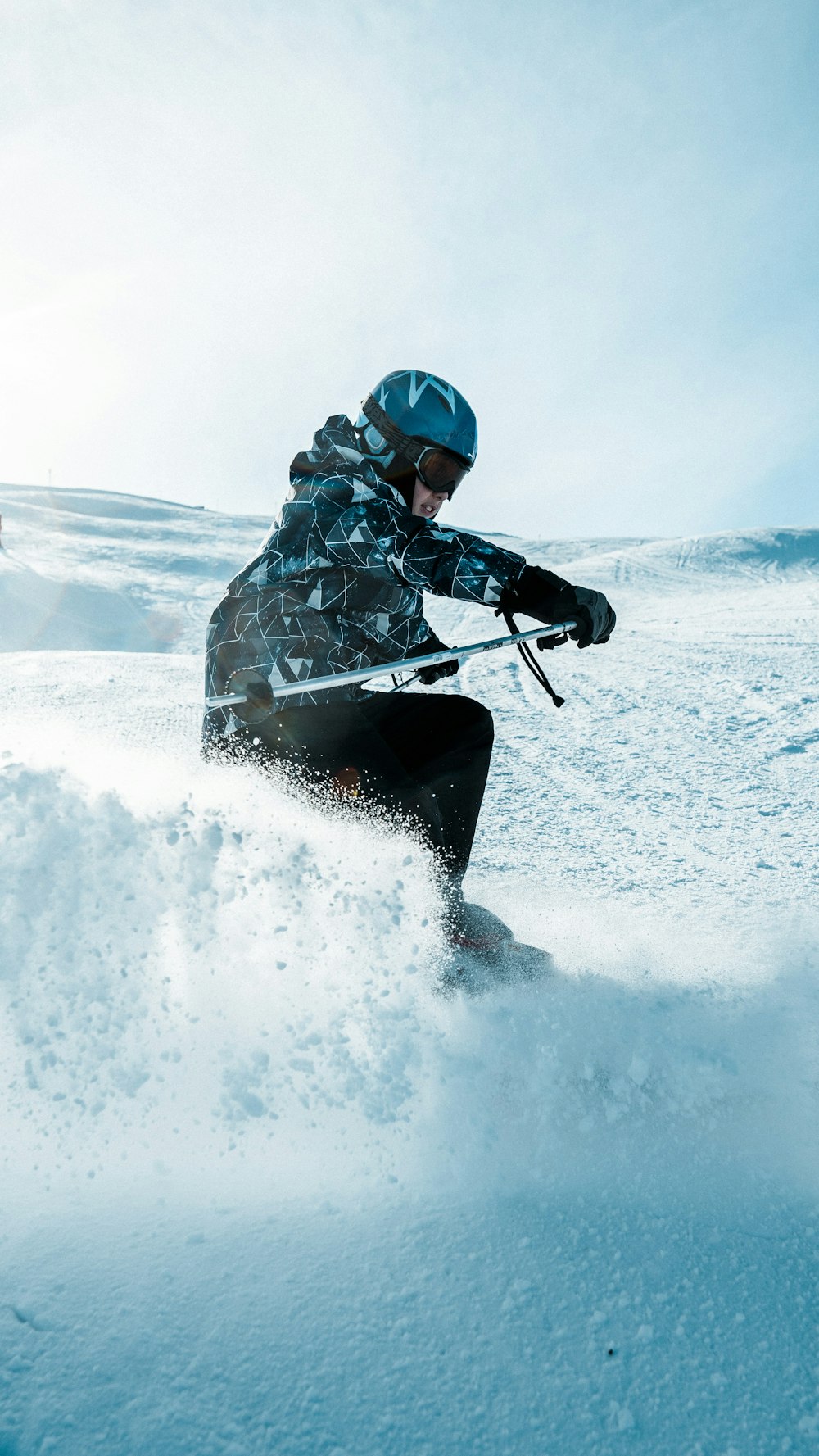 man in black and gray jacket riding black snow board during daytime