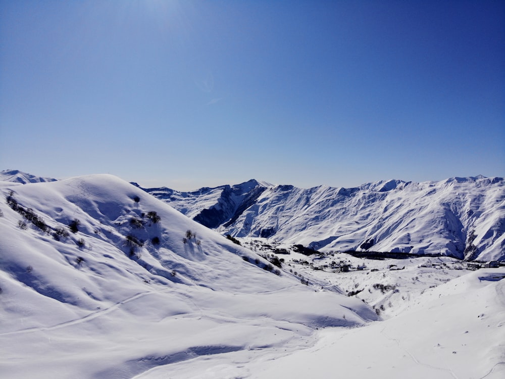 snow covered mountain under blue sky during daytime