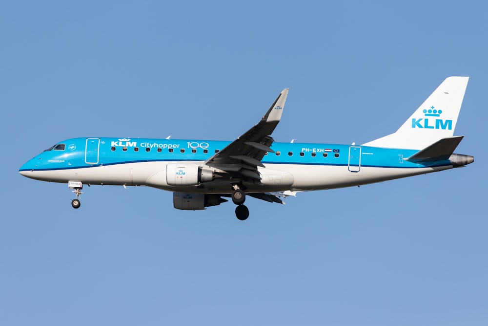 blue and white passenger plane in the sky