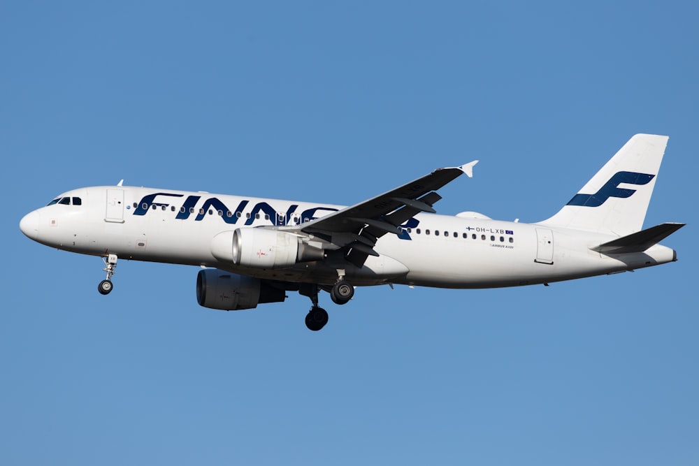 white and blue passenger plane in the sky