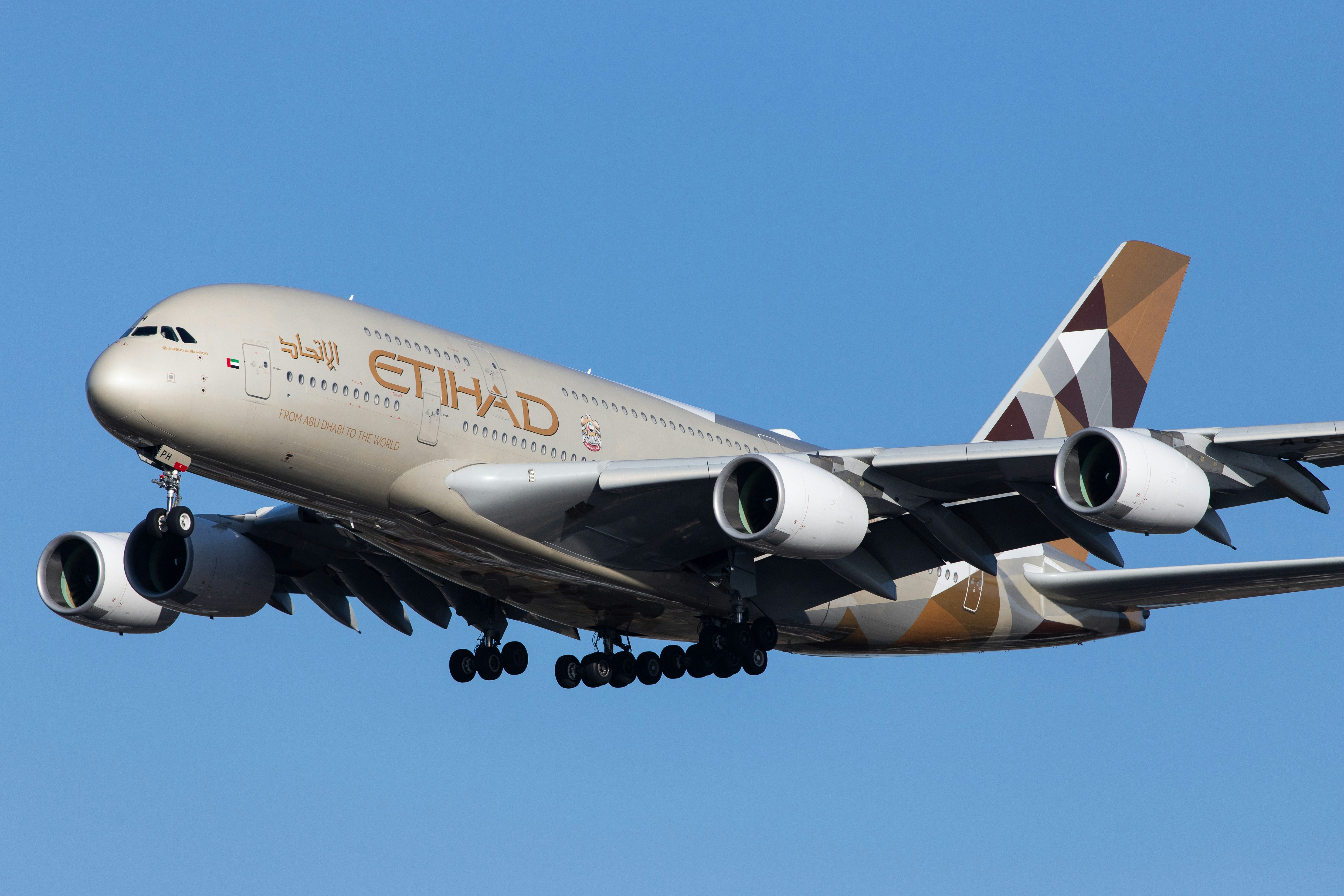 white and blue passenger plane flying during daytime