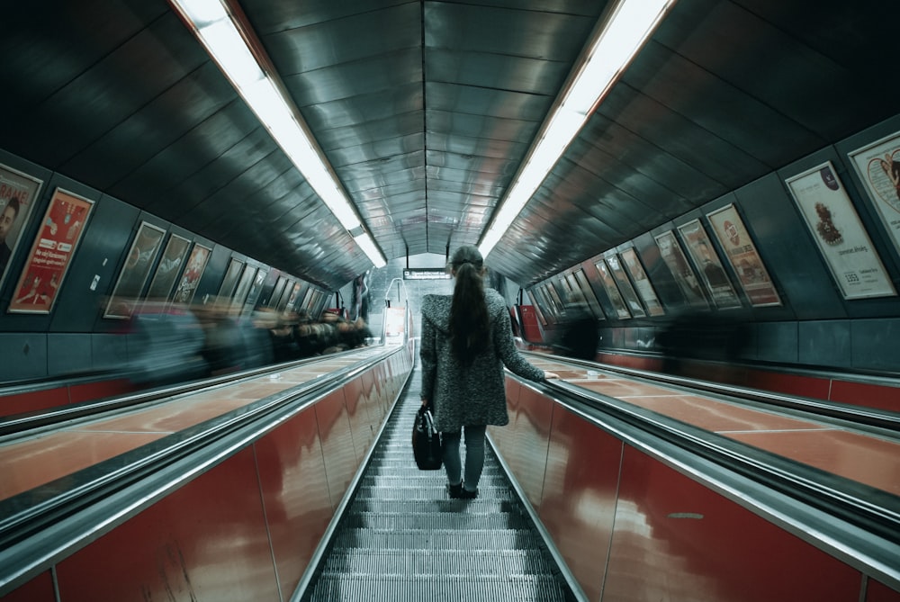 woman in black coat standing on train station