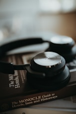 black and silver headphones on brown and black textile