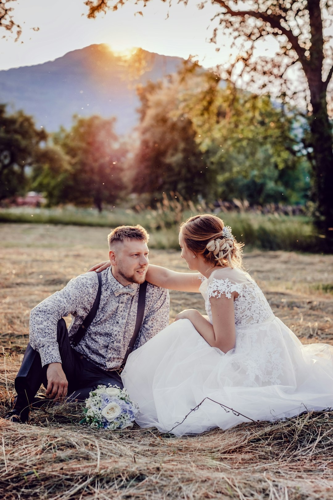 woman in white dress sitting beside man in black and gray long sleeve shirt