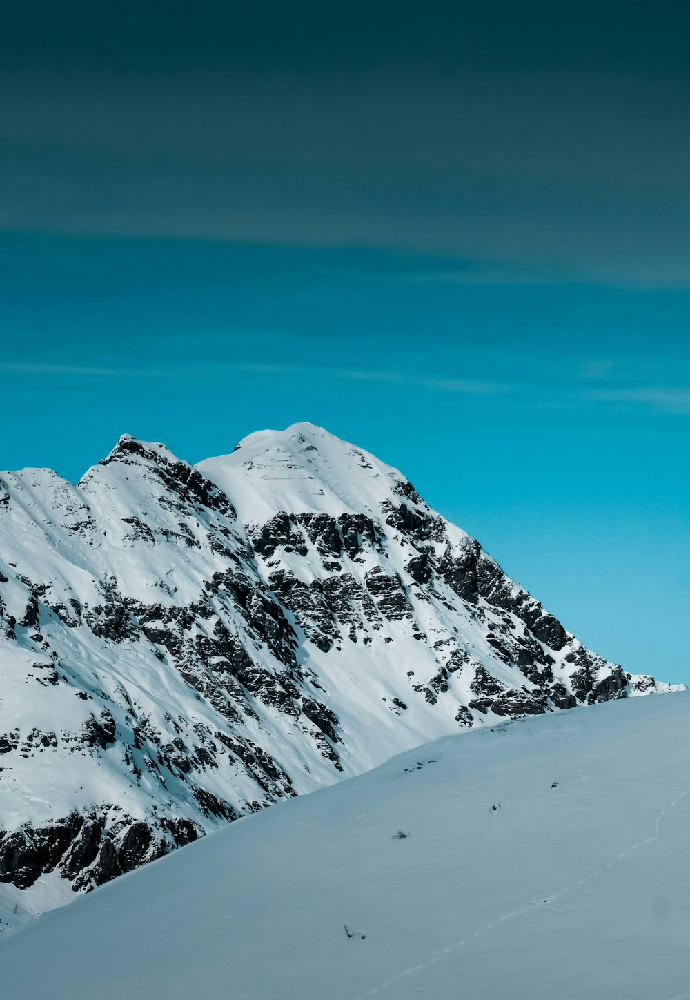 snow covered mountain under blue sky during daytime