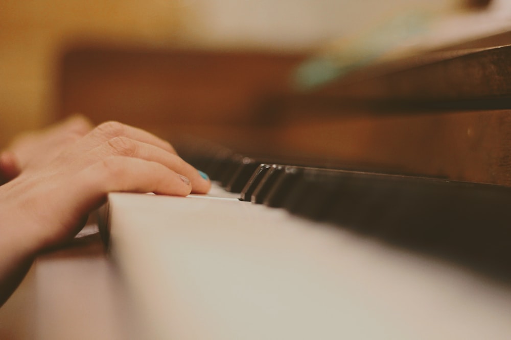 person playing piano in close up photography