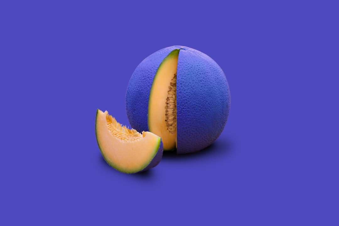 two green and yellow round fruits, Painted cantaloupe melon