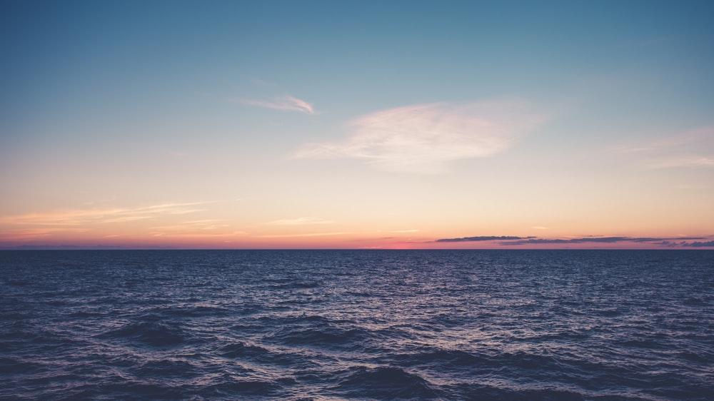 blue sea under blue sky during sunset