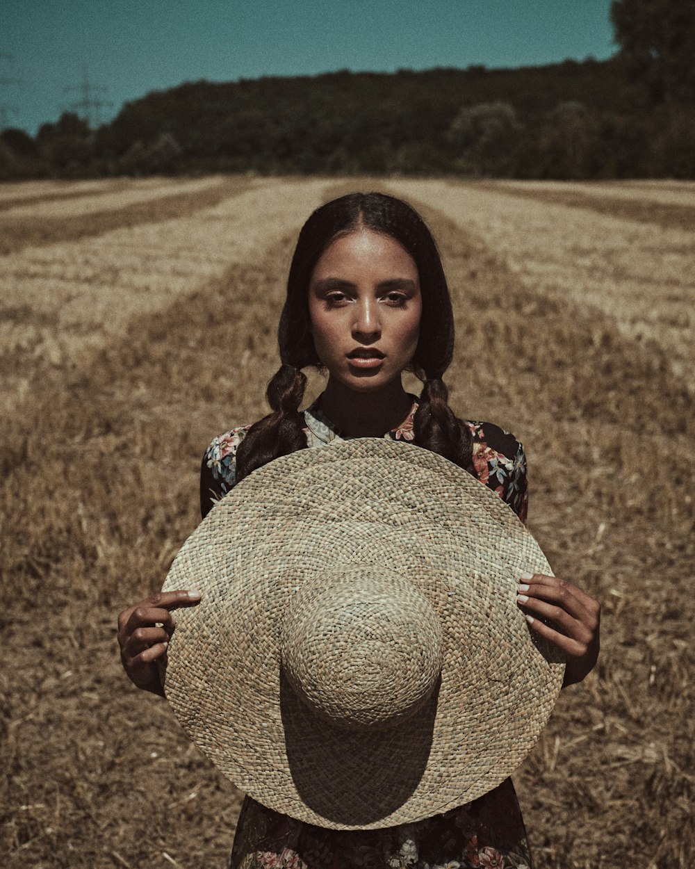 girl in brown hat on brown field during daytime