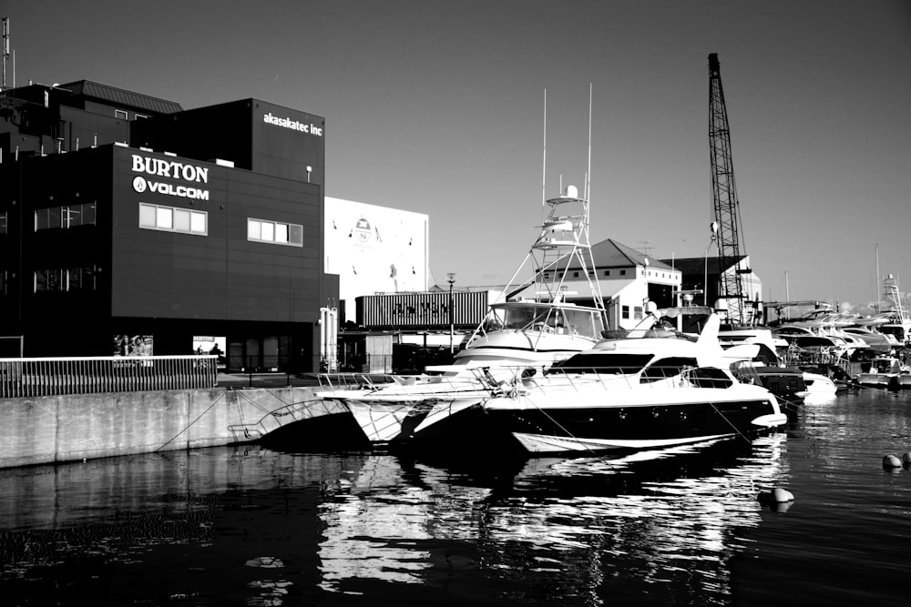 grayscale photo of boat on dock