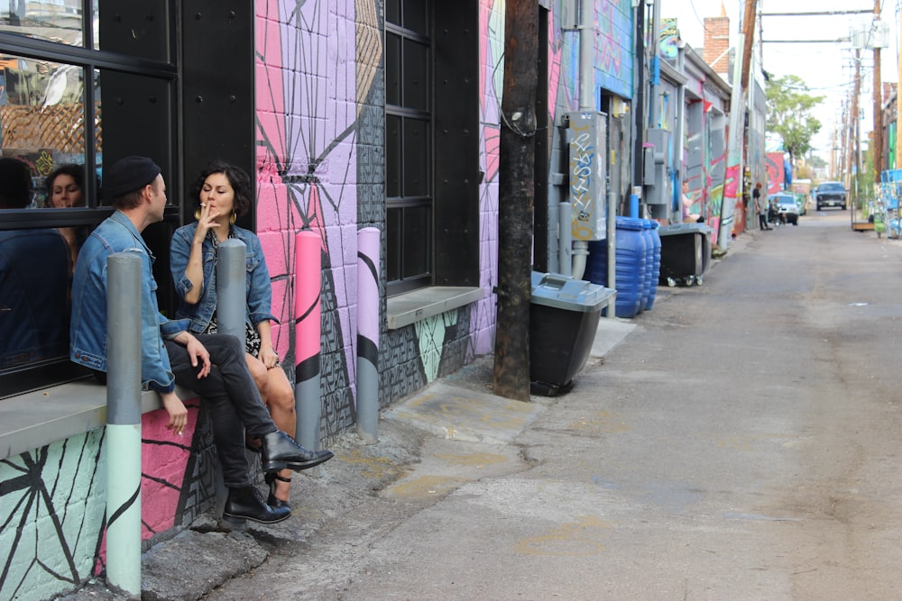 woman in black jacket sitting on black metal bench