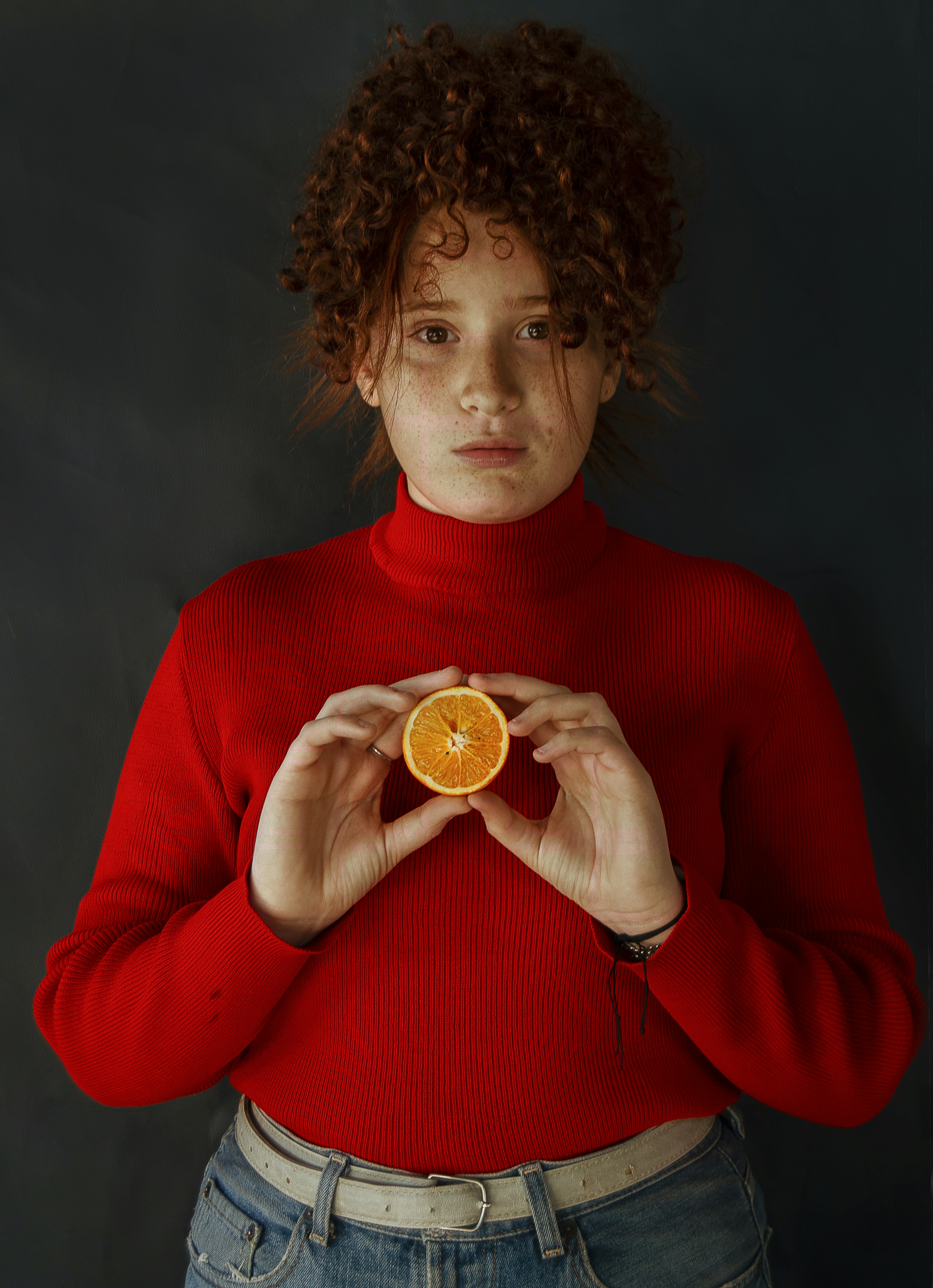 woman in red long sleeved shirt holding gold round coin