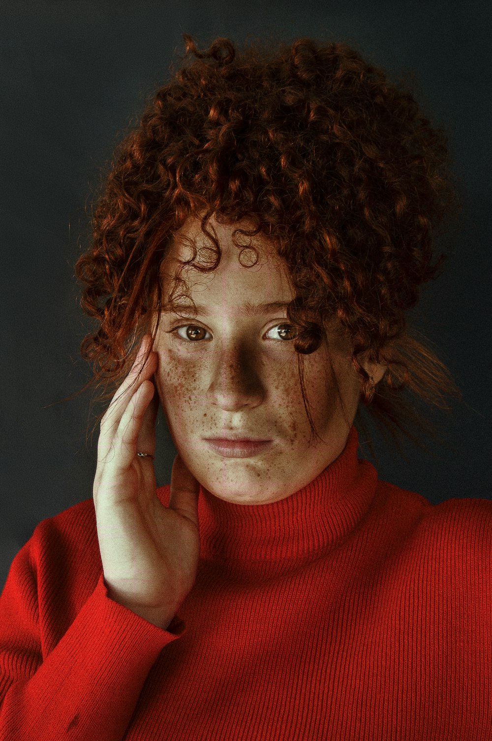 woman in red turtleneck sweater wearing silver framed eyeglasses