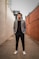 man in gray suit jacket and black pants standing on brown concrete pathway during daytime