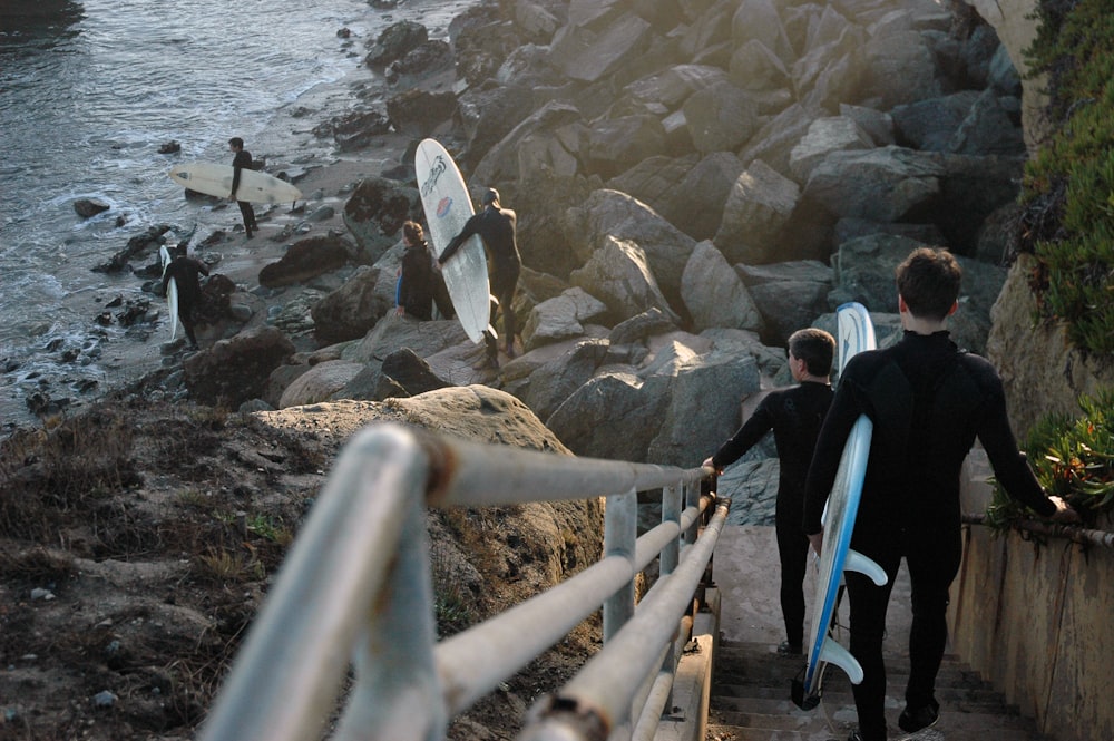 people walking on brown wooden bridge