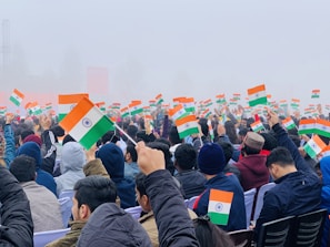people gathering on a street with flags during daytime