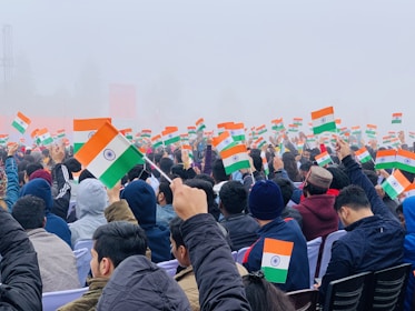 people gathering on a street with flags during daytime