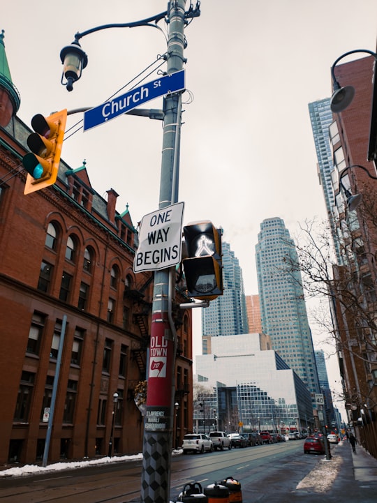 white and black street sign in Downtown Toronto Canada