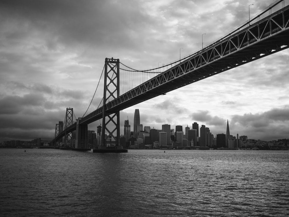 grayscale photo of bridge over body of water