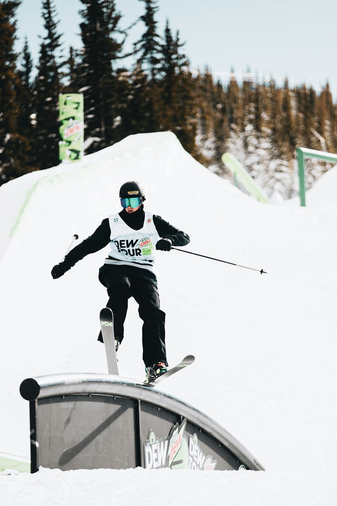 man in blue jacket and black pants riding on black snowboard during daytime