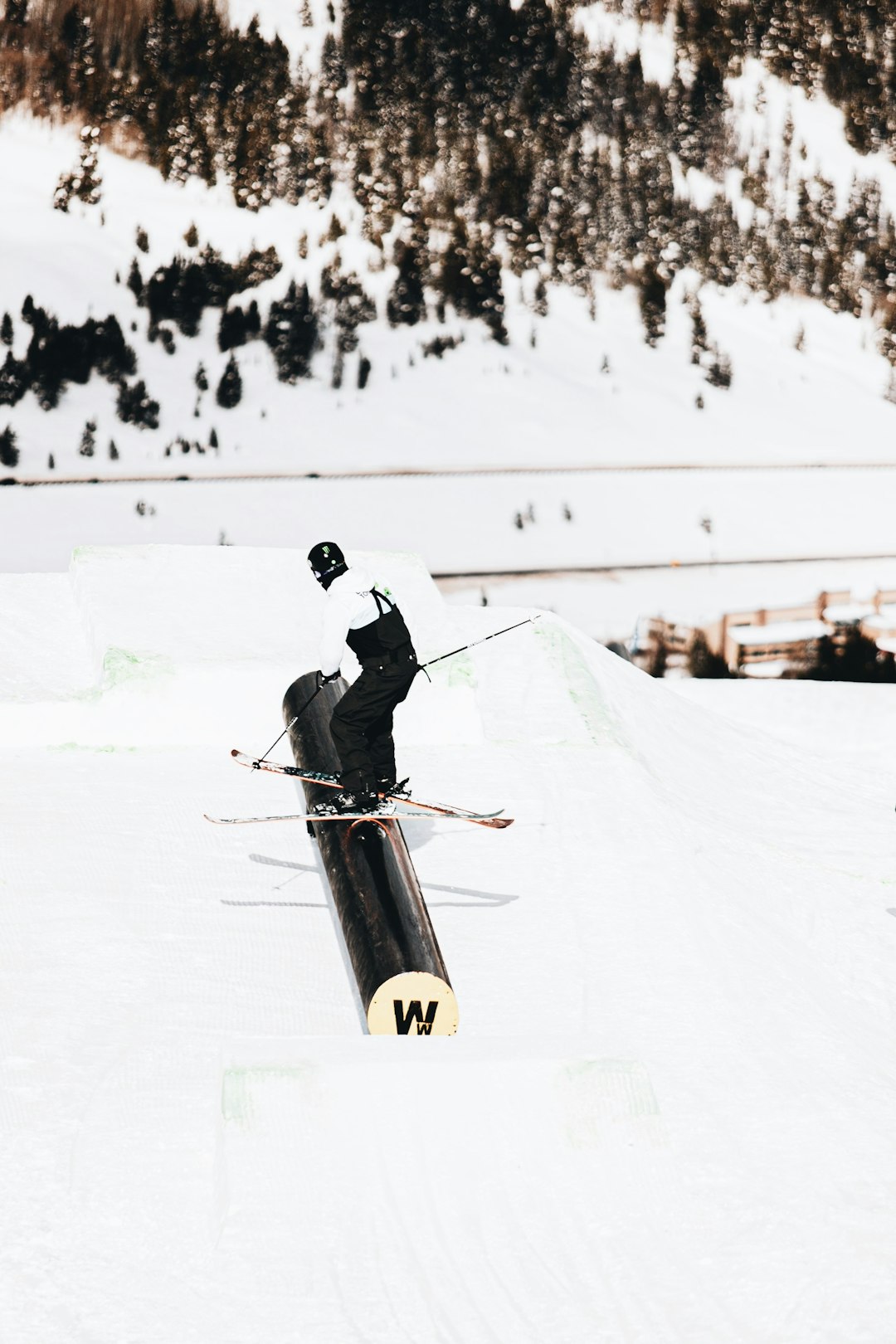 man in black jacket and black pants riding on snowboard during daytime