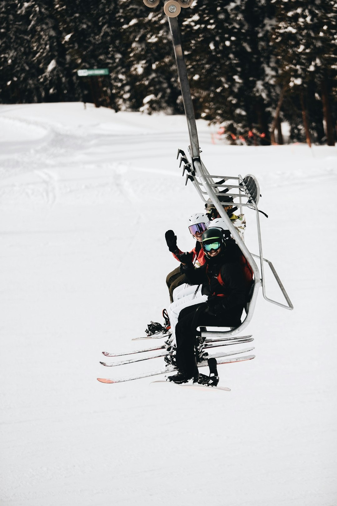 man in black jacket and red pants riding ski blades on snow covered ground during daytime