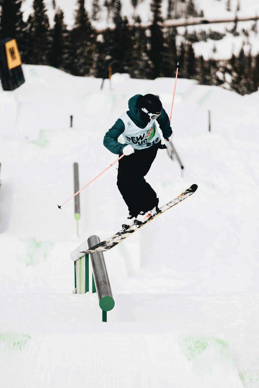 man in blue jacket and black pants riding on ski blades on snow covered ground during