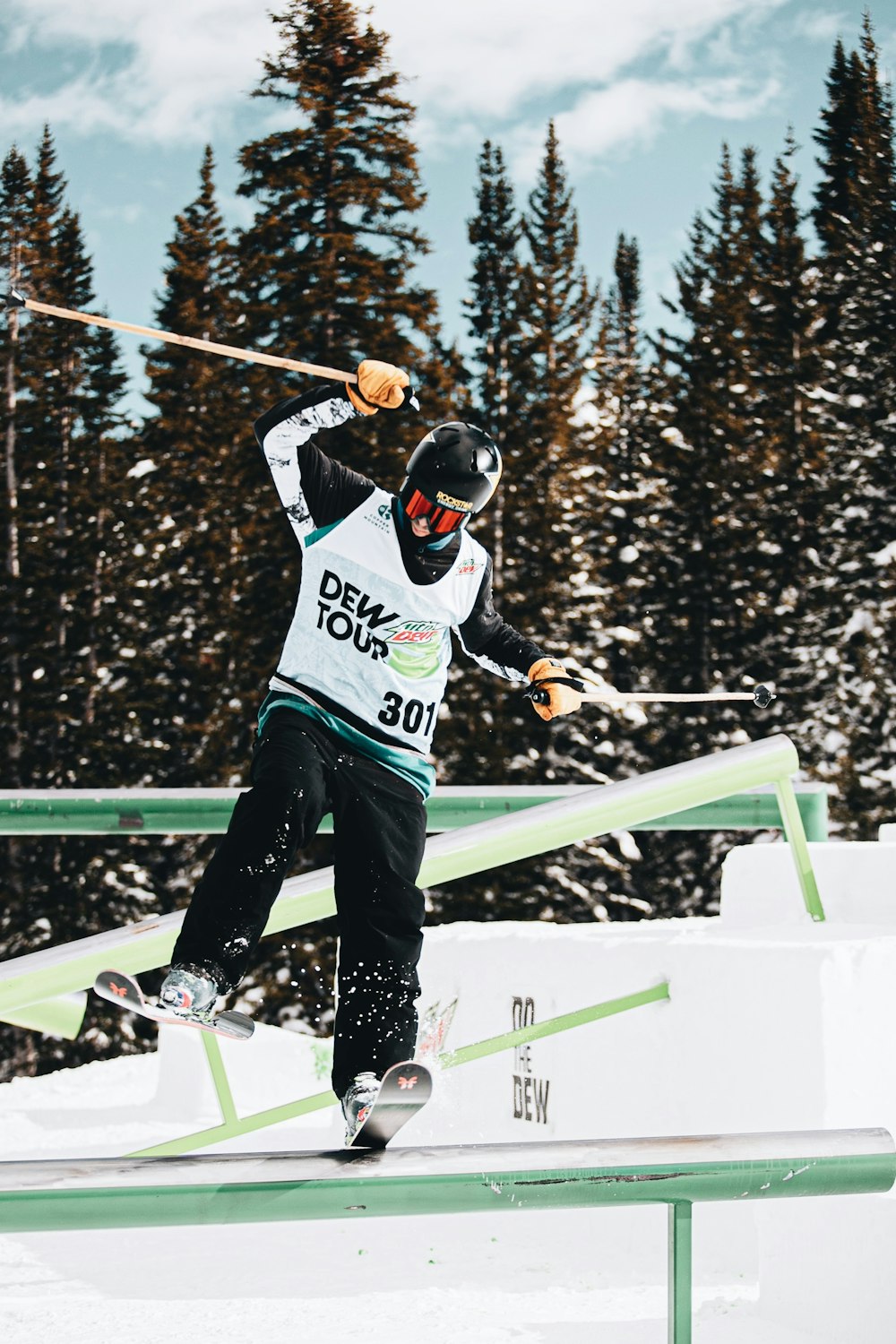 man in blue and white ice hockey jersey and blue pants riding on ski blades