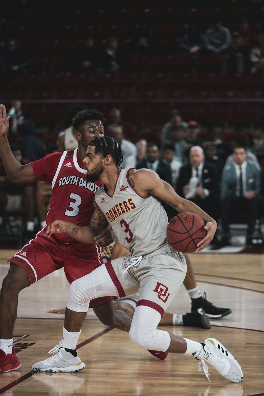 man in red jersey shirt playing basketball