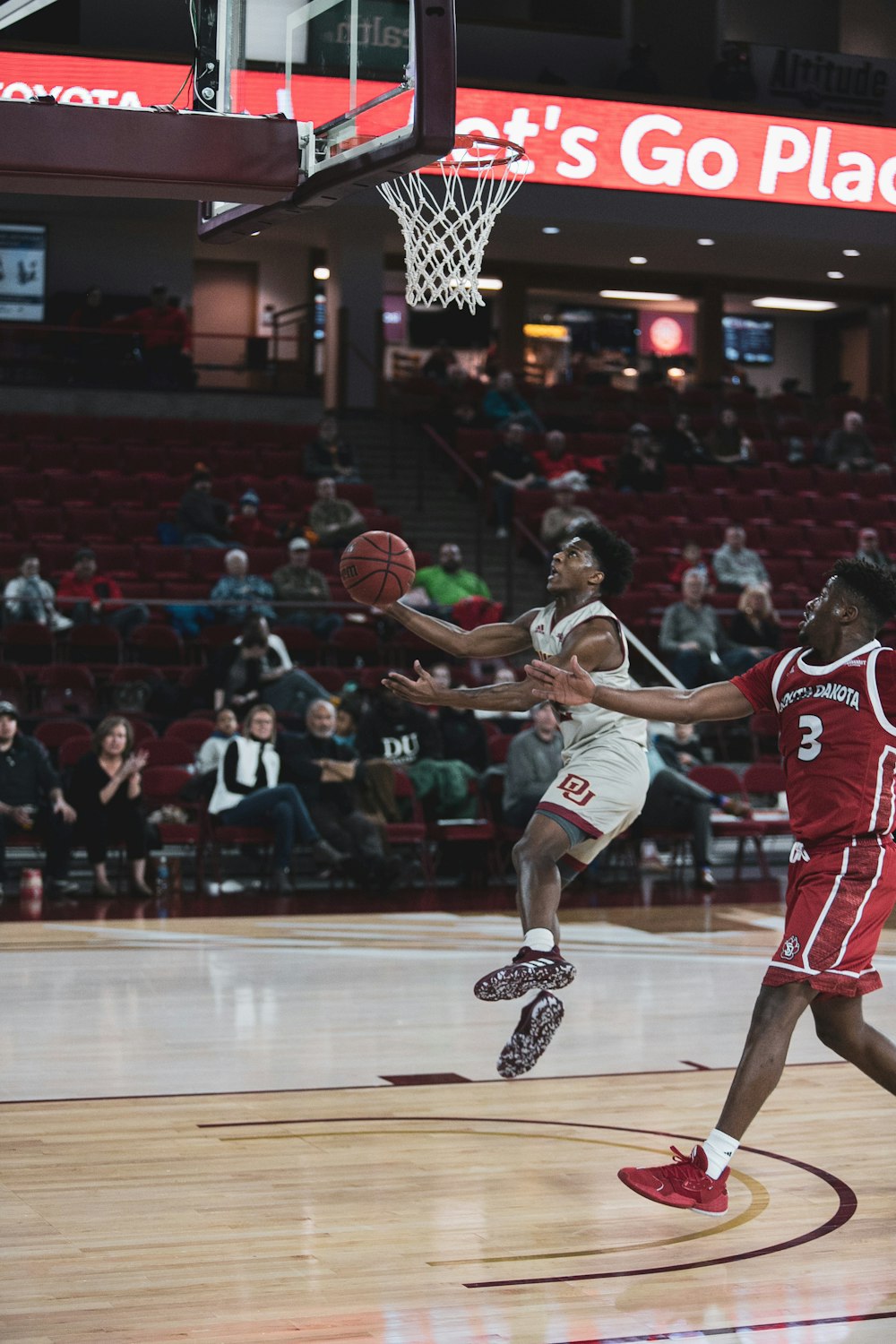 man in red jersey shirt playing basketball