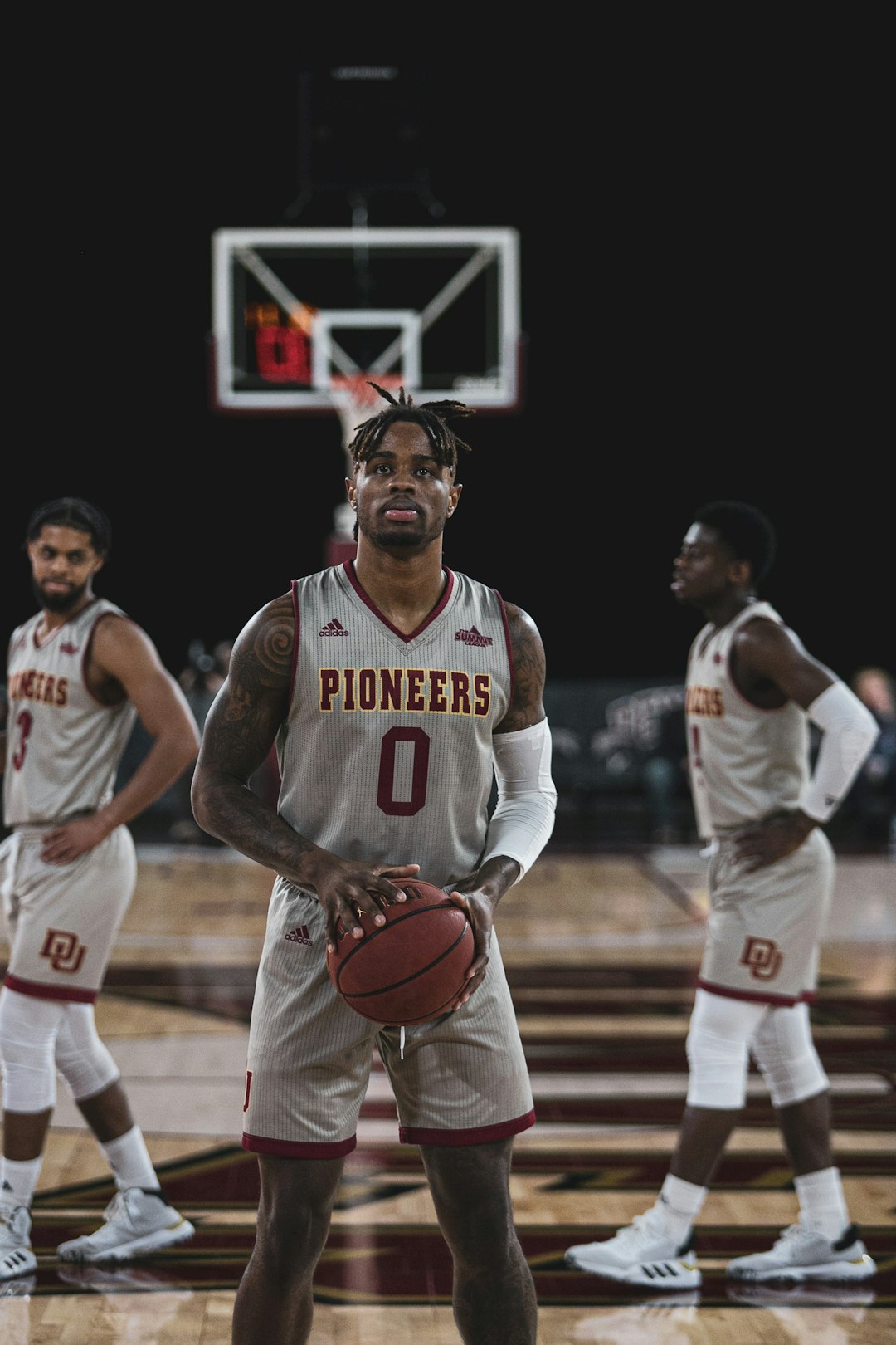 man in white and red basketball jersey holding basketball