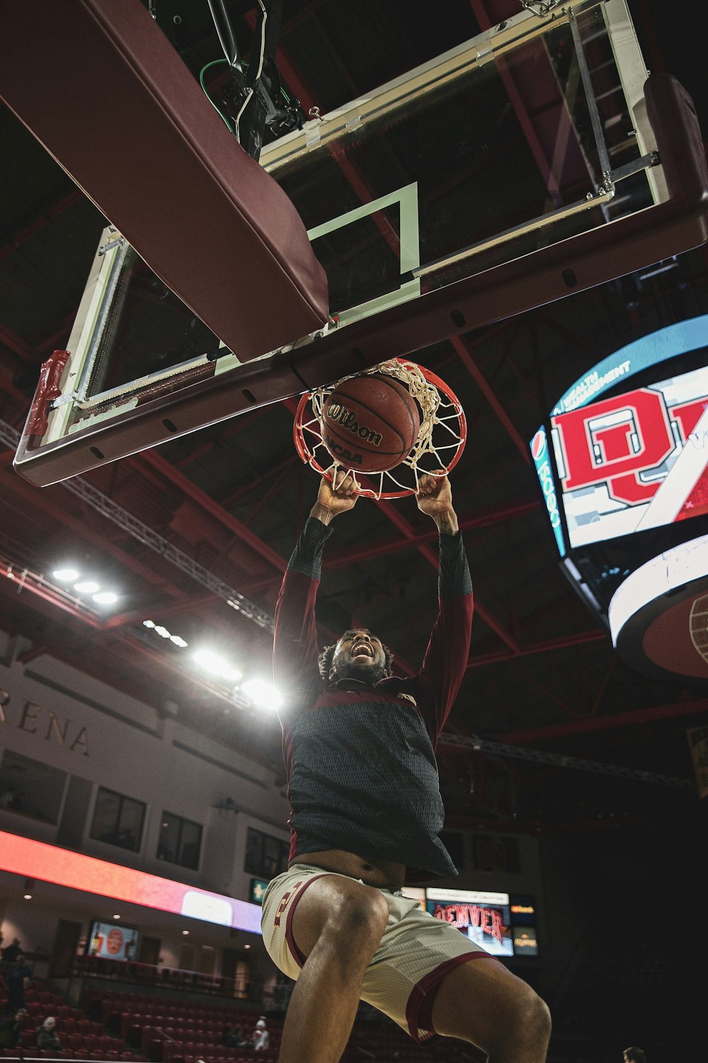 a man dunking a basketball in a gym