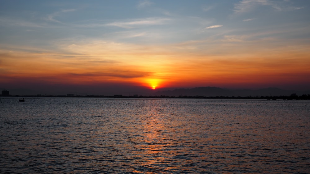 body of water during sunset