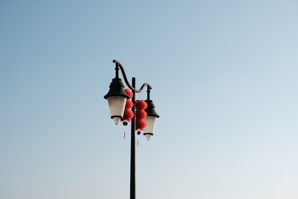 black and red street light under gray sky