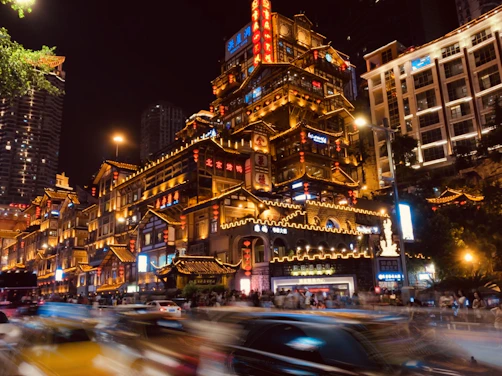 cars on road near buildings during night time
