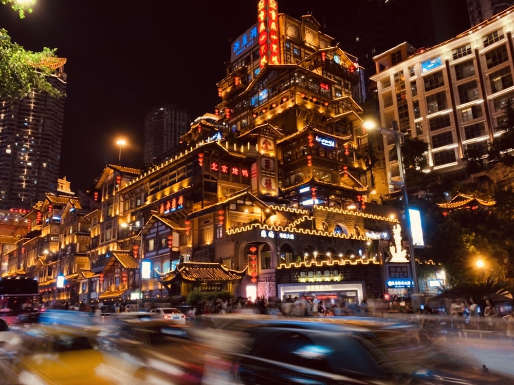 cars on road near buildings during night time