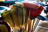 A collection of colorful brooms arranged neatly.