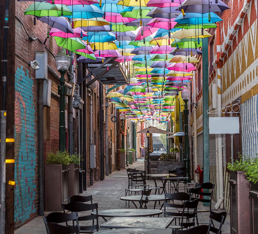 chaises et table en métal noir avec parasol dans la rue