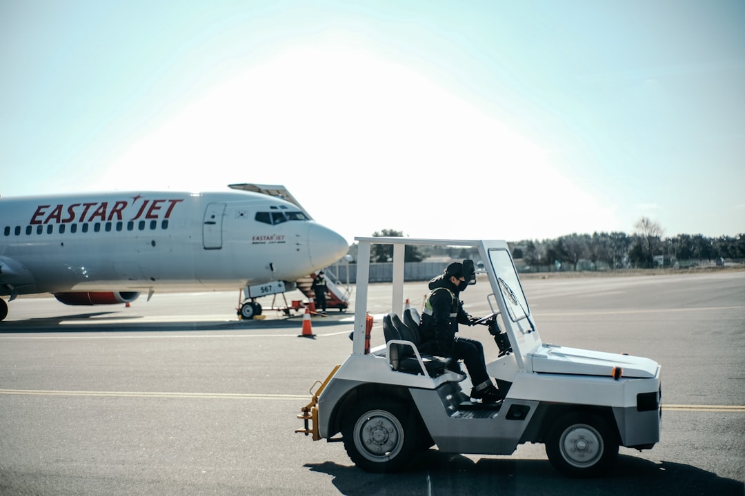 white and black airplane on gray concrete road during daytime