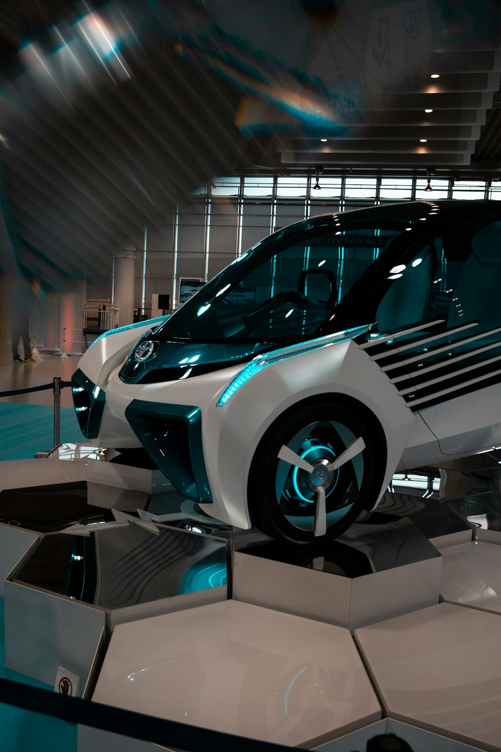 a futuristic car on display in a building