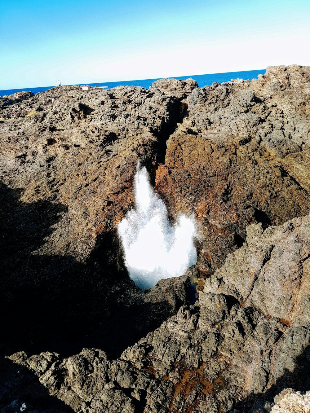 brown rock formation with white clouds during daytime