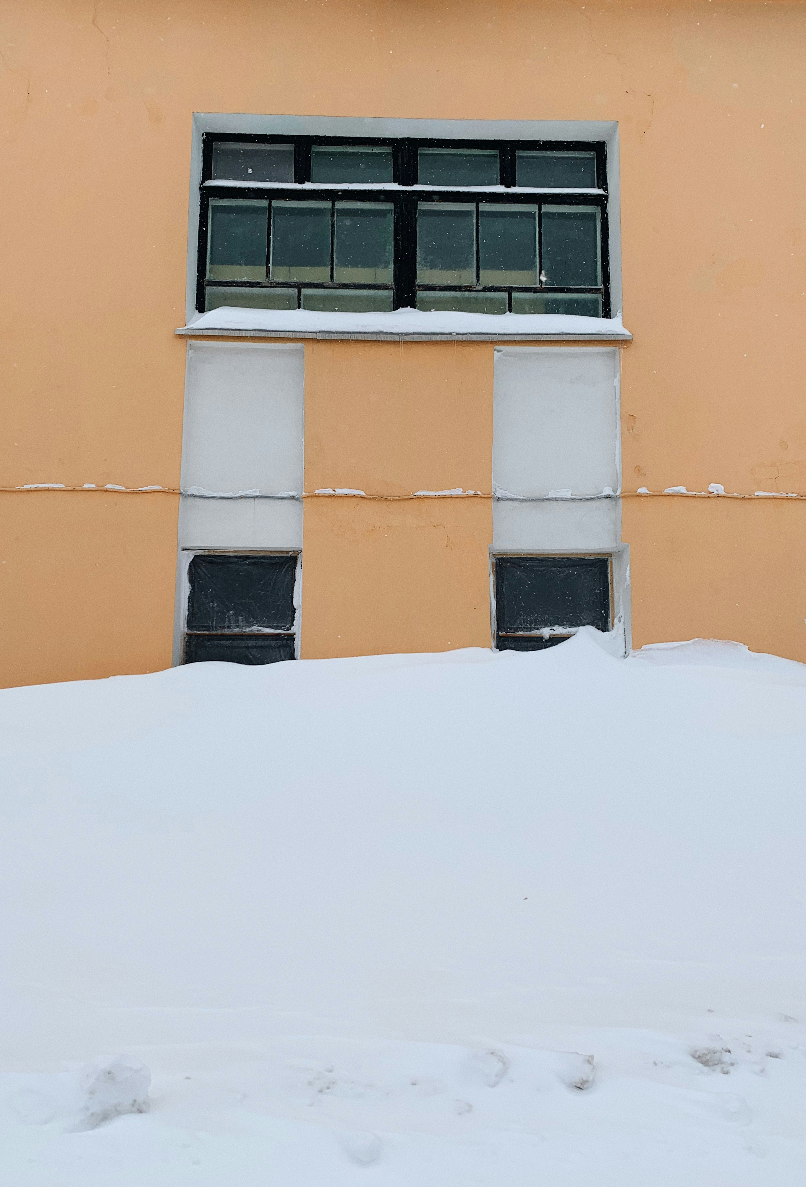 orange concrete building with black window frame