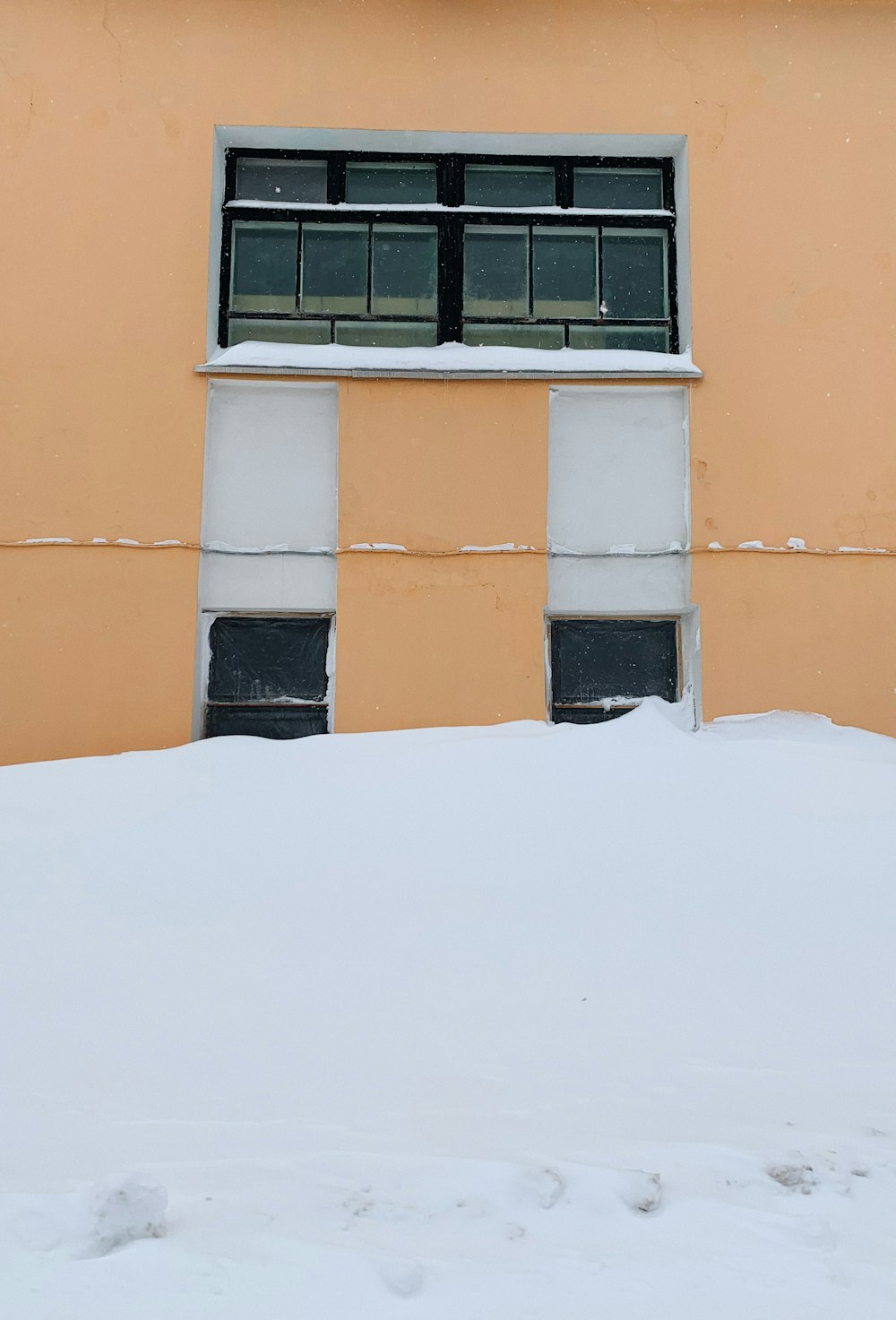 orange concrete building with black window frame