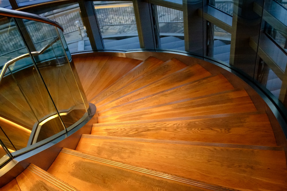 brown wooden round table near glass window