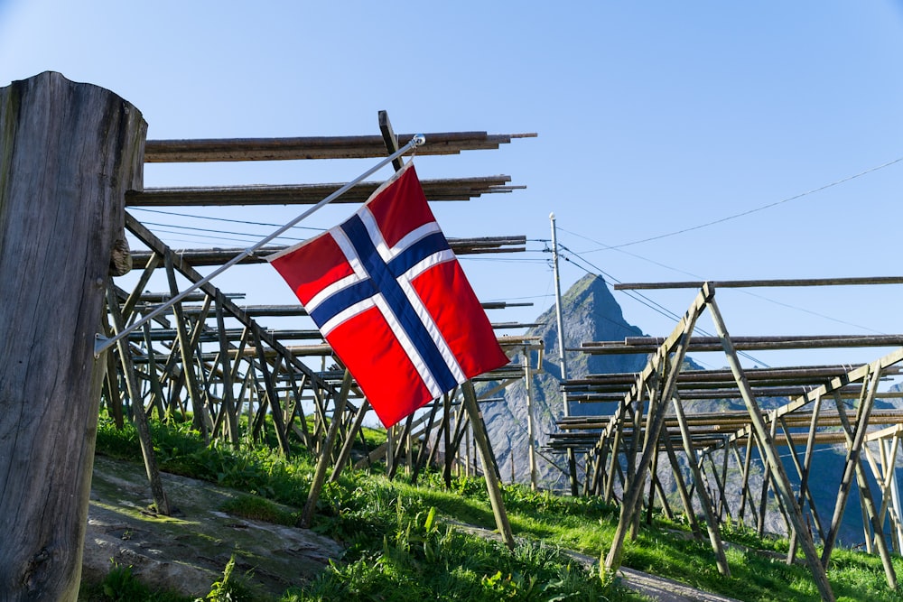 red white and blue flag on brown wooden pole during daytime