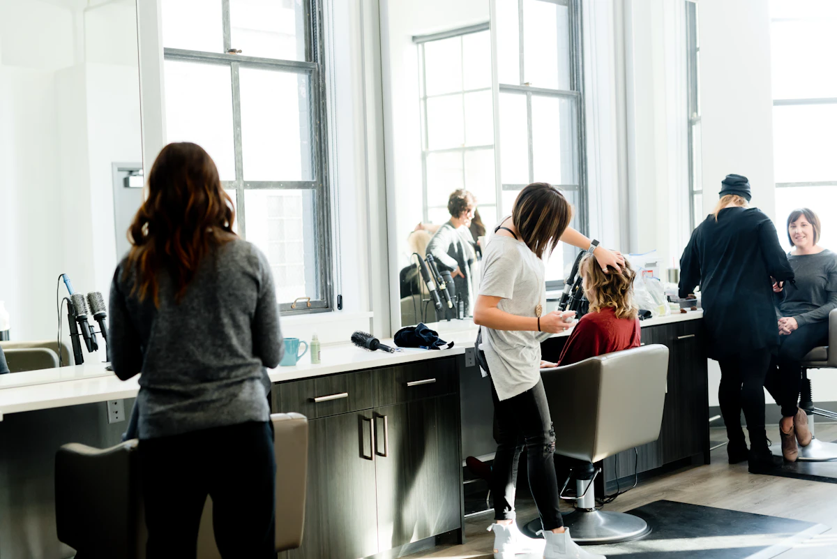 Detail of a stylist sectioning hair during a colour service