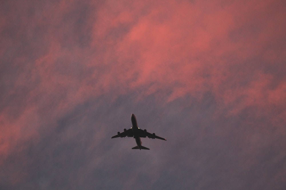 black airplane flying in the sky