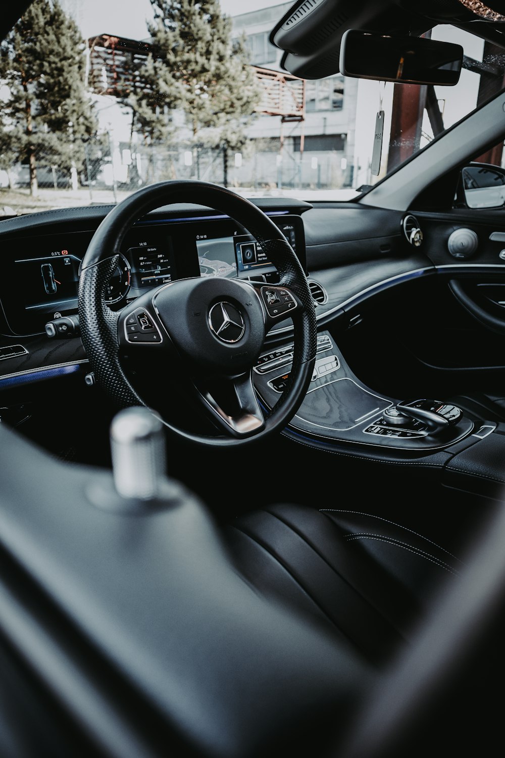 black car steering wheel during daytime