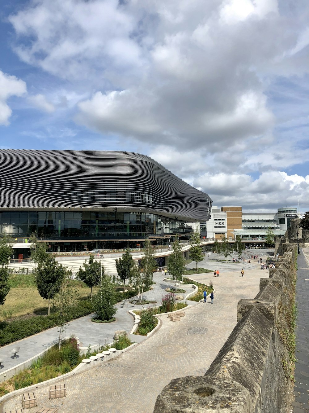 brown and white concrete building under white clouds during daytime