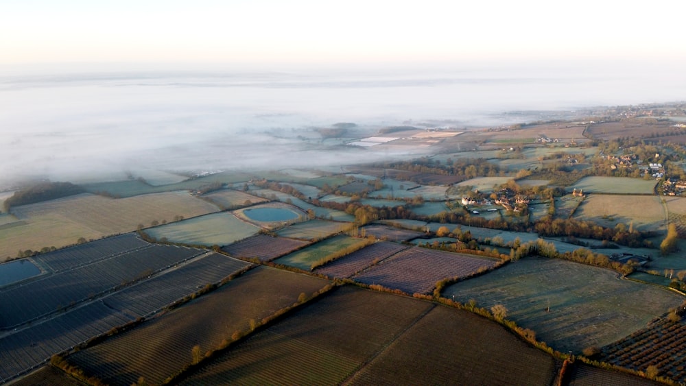 aerial view of green field under cloudy sky during daytime